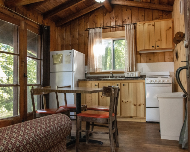 Picture of the cabin kitchen, showing an oven and fridge with a small counter space